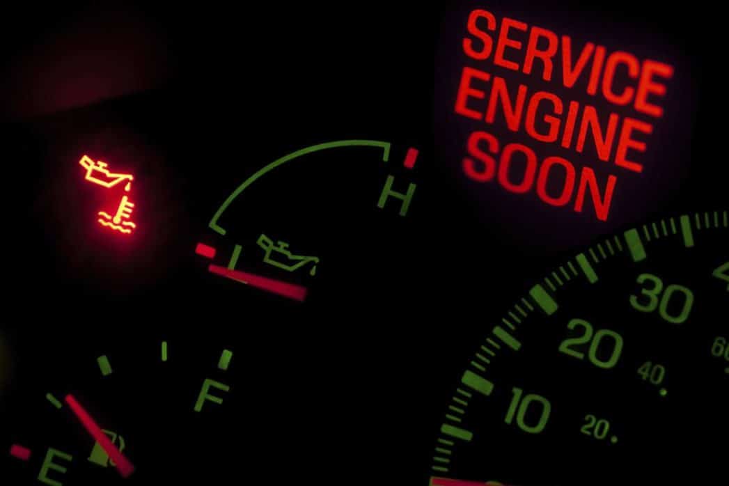 A car's dashboard with the words service engine soon lit up