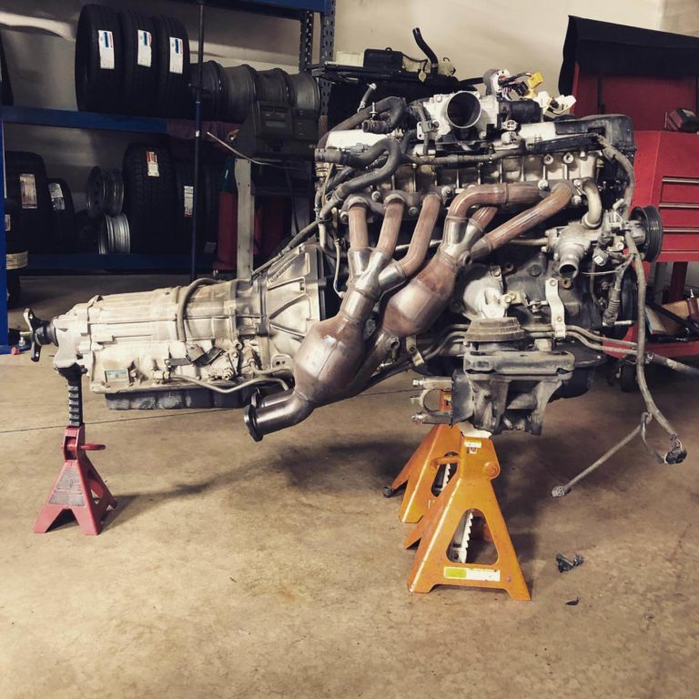 Engine & Transmission Replacement at Ace Performance, Queen Creek, AZ; An engine sitting on-top of equipment, waiting to be repaired