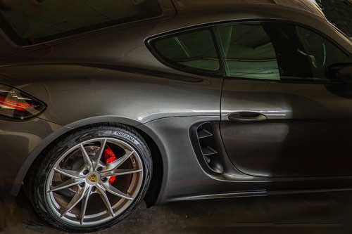 A Look at Touring Tires vs. Performance Tires for Your Car with Ace Performance Automotive in Queen Creek AZ closeup image of Yokohama brand performance tires on gun metal gray Porsche