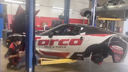 When to Make Auto Repair in Queen Creek, AZ a Top Priority with Ace Performance Automotive, image of technician at the shop working on Torco street car in shop bay