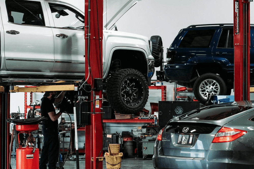 Fall car maintenance, auto repair in Queen Creez, AZ by APA Auto & Fleet Care. Image of multiple vehicles on lifts inside a professional repair facility, representing the shop’s dedication to precision, quality workmanship, and complete auto care for every customer.